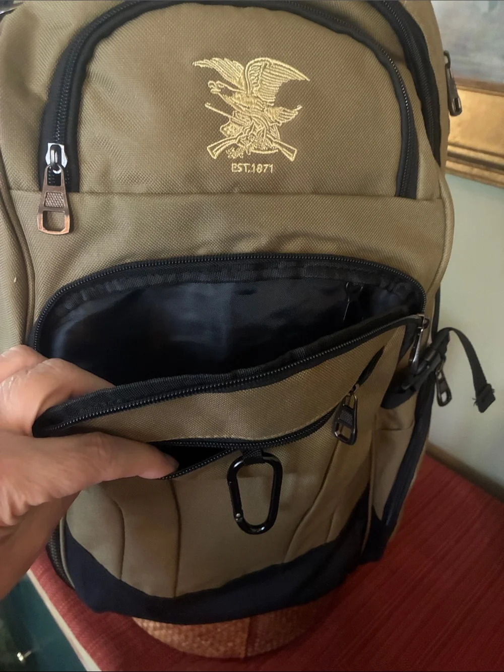 NRA Tactical Backpack Multi-Pocket in tan with black accent panels, EST 1871